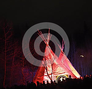 Teepee With Red Light Against A Dark Sky