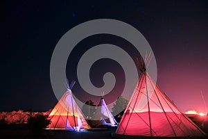 Teepees glowing at night in Marfa, Texas