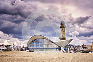 Teepott and lighthouse under dramatic clouds in WarnemÃÂ¼nde photo