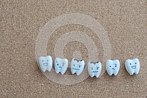 Teeth cartoon of health and decayed icon on wooden cork background for children education