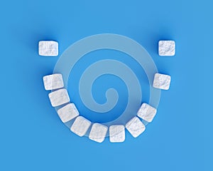 Teeth made of sugar cubes on blue background, some teeth missing. Sweet tooth dental health care concept
