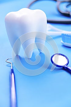 Teeth model and dentist tools on blue background