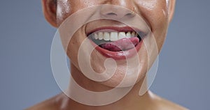 Teeth, mouth and tongue out, woman with beauty or dental, happy for dermatology and orthodontics on grey background