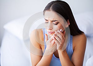 Teeth Problem. Woman Feeling Tooth Pain. Closeup Of A Beautiful Sad Girl Suffering From Strong Tooth Pain. Attractive