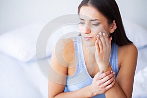 Teeth Problem. Woman Feeling Tooth Pain. Closeup Of A Beautiful Sad Girl Suffering From Strong Tooth Pain. Attractive