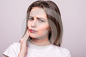 Teeth Problem. Woman Feeling Tooth Pain. Closeup Of A Beautiful Sad Girl Suffering From Strong Tooth Pain. Attractive Female Feeli