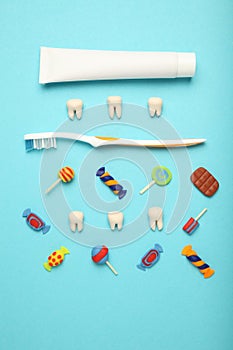Teeth with sweet candies. Tooth caries in children`s, dental healthcare, toothpaste and toothbrush