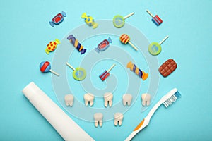 Teeth with sweet candies. Tooth caries in children`s, dental healthcare, toothpaste and toothbrush