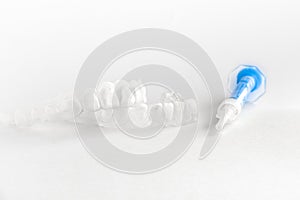 Teeth tray for dental whitening opalescence and bleaching gel syringe photo