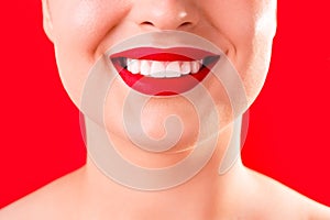 Teeth whitening. Healthy white smile close up. Beauty woman with perfect smile- lips and teeth. Beautiful Model Girl with red lips