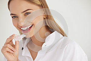 Teeth Whitening. Woman with White Smile, Using Removable Braces