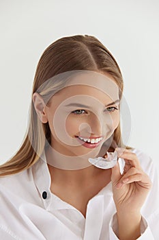 Teeth Whitening. Woman with White Smile, Using Removable Braces