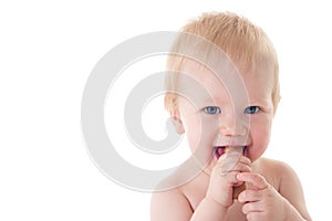 Teething baby chewing on rusk