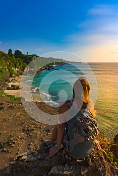 Tourist admires Tegal Wangi Beach Badung Bali Indonesia photo