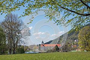 Tegernsee castle and brewery, view through green branches