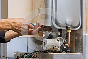 Tehnic fix the problem servicing with residential heating equipment on gas boiler for hot water and heating