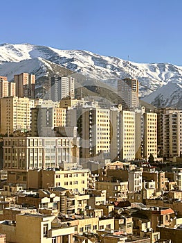 Tehran City View with Snow Alborz Mountains background