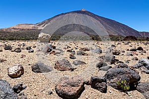 Teide - Pumice stones on desert plain La Canada de los Guancheros. Scenic view on volcano Pico del Teide photo