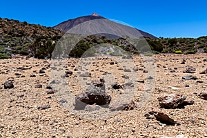 Teide - Pumice stones on desert plain La Canada de los Guancheros. Scenic view on volcano Pico del Teide photo