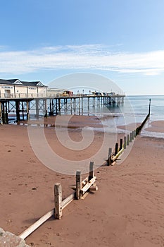 Teignmouth Pier Devon blue sky and sandy beach