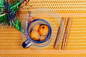 Tejocote fruits in a cup, traditional mexican pinata and cinnamon photo