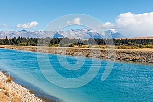 Tekapo canal in Mackenzie Country with Southern Alps in background, New Zealand photo