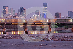 Tel-Aviv bridge and river in front of the city skyscrapers