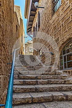 Tel-Aviv Israel May 19, 2019 View of a narrow stone street through a staircase in the old city of Jaffa, with the old houses still