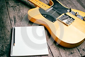 Telecaster with notepad on wood table