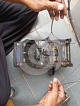 Telecom officer is connecting broken fiber optic cable