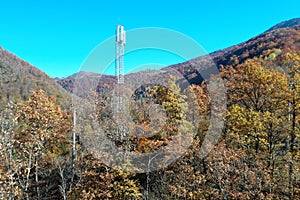 The telecom tower with blue sky. Telecommunications antenna tower in the morning.