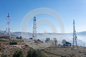 The telecom tower with blue sky. Telecommunications antenna tower in the morning.