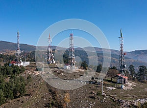 The telecom tower with blue sky. Telecommunications antenna tower in the morning.