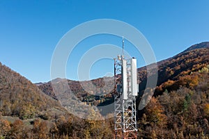 The telecom tower with blue sky. Telecommunications antenna tower in the morning.