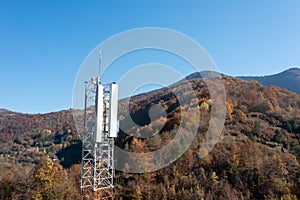 The telecom tower with blue sky. Telecommunications antenna tower in the morning.