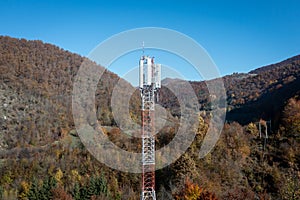 The telecom tower with blue sky. Telecommunications antenna tower in the morning.