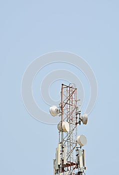 Telecommunication antenna mobile tower with blue sky background.