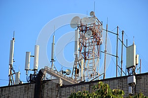 Telecommunication base stations network repeaters on the roof of the building. The cellular communication aerial on a building roo