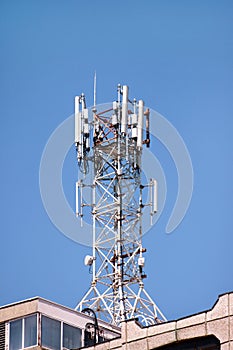 Telecommunication base stations network repeaters on the roof of building. The cellular communication aerial on city building roof