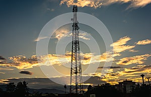 Telecommunication cellular tower in sunset sky