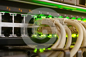 Telecommunication equipment is in the server room of the data center. Many Internet wires are connected to the main router. Gray