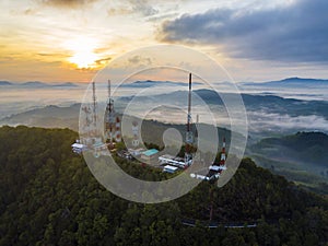 Telecommunication mast TV antennas at sunrise on mountain