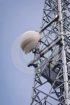 Telecommunication mast TV antennas wireless technology with blue sky.