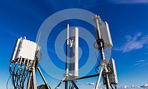 Telecommunication masts with microwave, radio panel antennas, outdoor remote radio units, power cables, coaxial cables