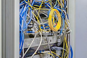 Telecommunication panel with random interweaving of wires. Internet communication cables are connected to telephony ip switches.