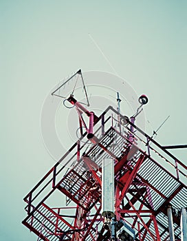 Telecommunication radio signal tower over the blue sky