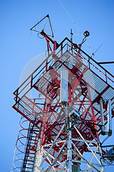 Telecommunication radio signal tower over the blue sky