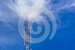 Telecommunication radio wave signal tower red and white with cloudy. Steel truss of transmission signal antenna with blue sky.