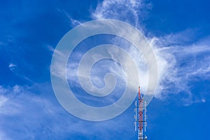 Telecommunication radio wave signal tower red and white with cloudy. Steel truss of transmission signal antenna with blue sky.