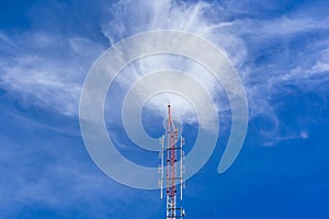 Telecommunication radio wave signal tower red and white with cloudy. Steel truss of transmission signal antenna with blue sky.